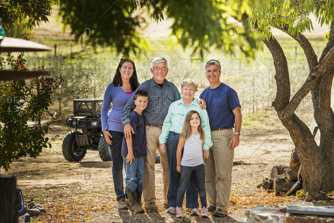 Family smiling in olive grove