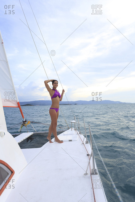 Attractive woman standing on sail boat deck