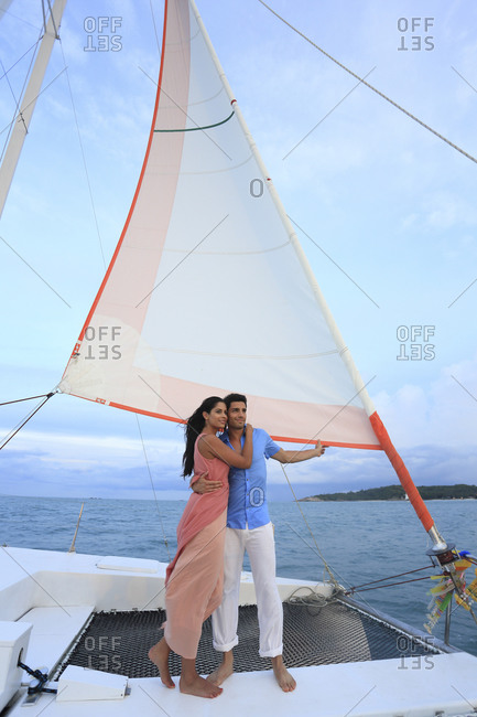 Couple standing on sail boat deck