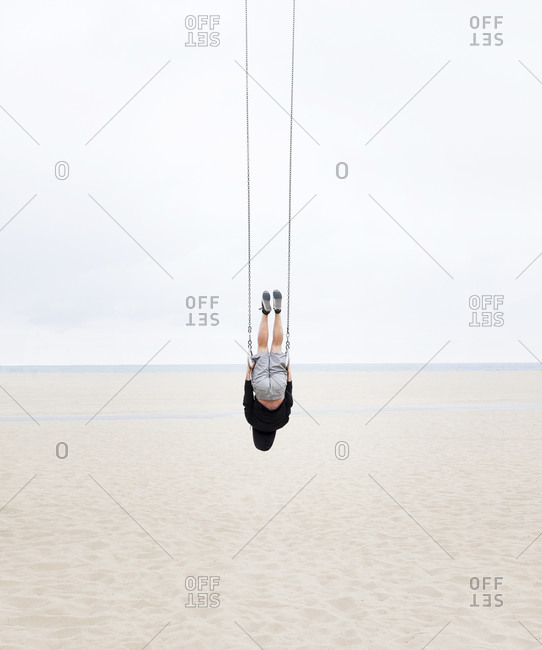 Caucasian man practicing gymnastics outdoors