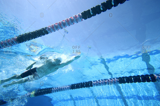 Man swimming lengths in swimming pool, underwater view