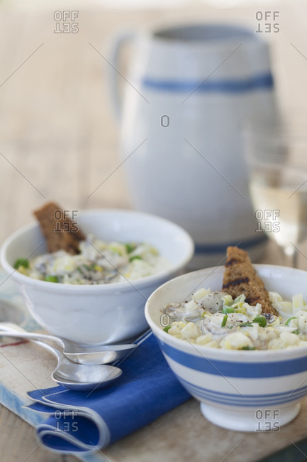 Two bowls of New England clam chowder with toast