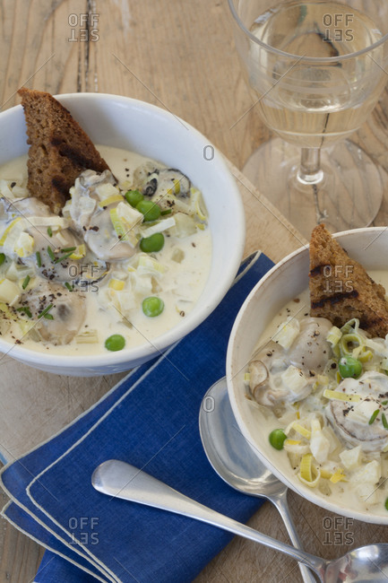 Two bowls of New England clam chowder with toast