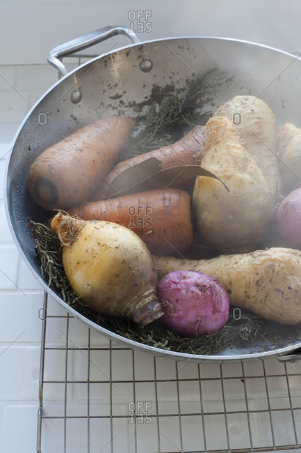 Steaming wok of various root vegetables
