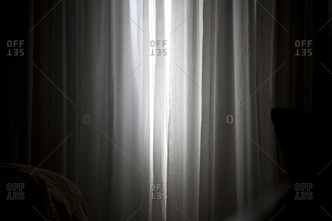 Sunlight coming in through slightly parted curtains in a bedroom