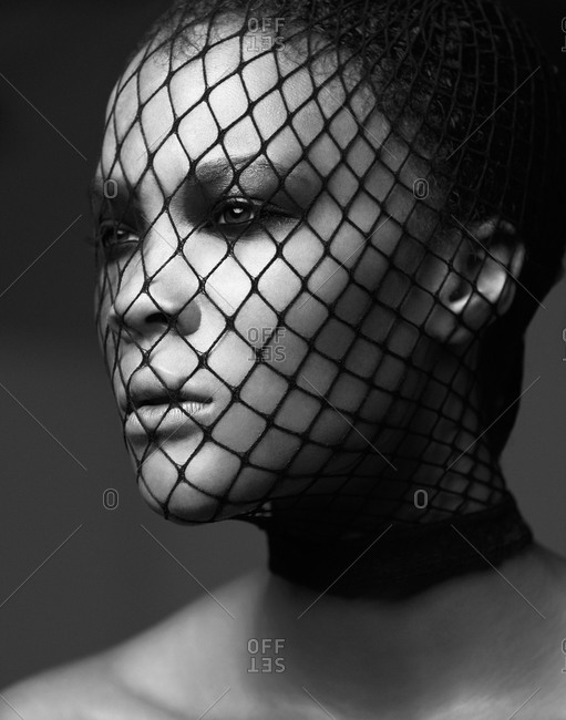 Head shot of dark-haired model with face net