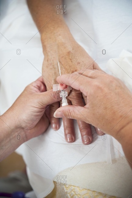 Nurse preparing a patient for an IV line.