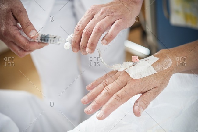 Nurse preparing a patient for an IV line.