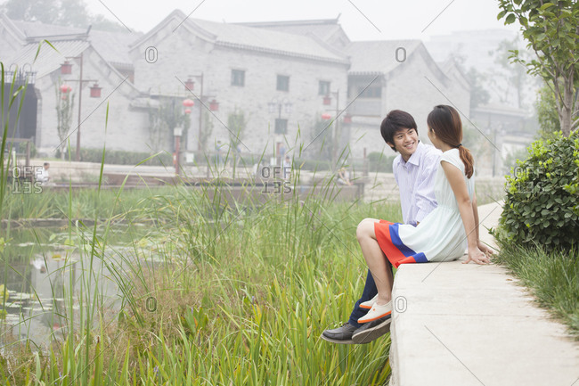 Chinese couple talking by creek