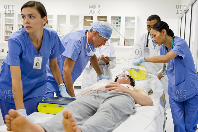 Doctors working on patient in the emergency room