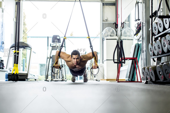 Pacific Islander man working out in gym
