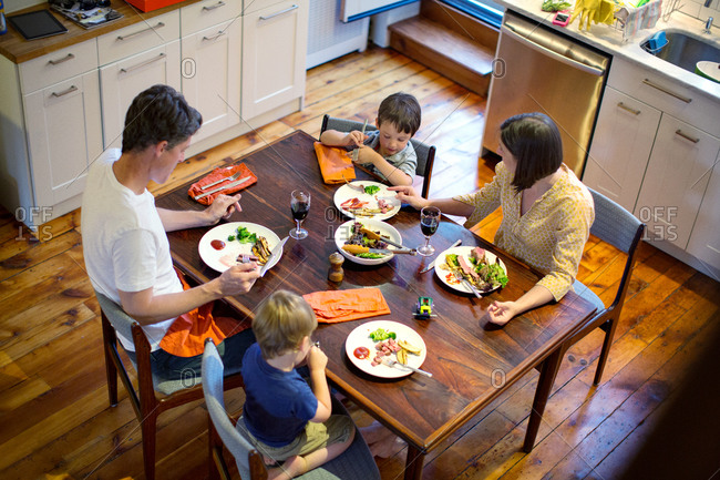 Overhead view of family eating dinner in kitchen