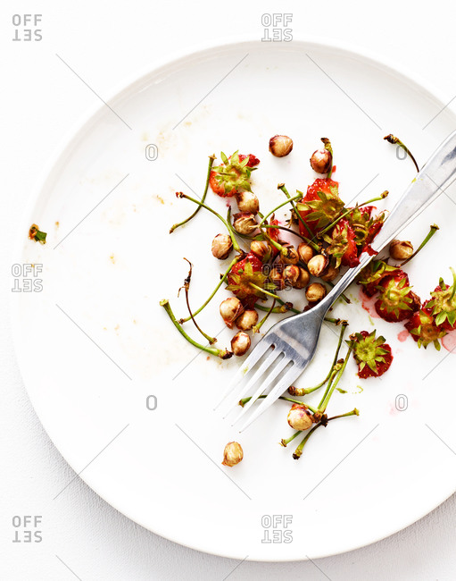 Cherry seeds and stems on plate