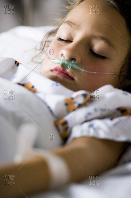 Young girl in hospital bed with respirator