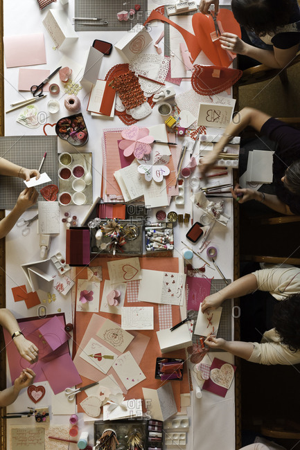 Top view of women making greeting cards for Valentine\'s day