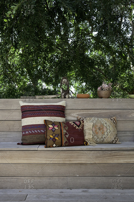Wooden bench with woven cushions