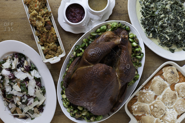 Thanksgiving menu with smoked turkey, cornbread stuffing, creamed collard greens and spiced sweet potato souffle