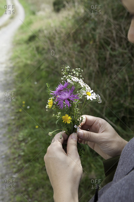 Woman holding a small bouquet of wildflower