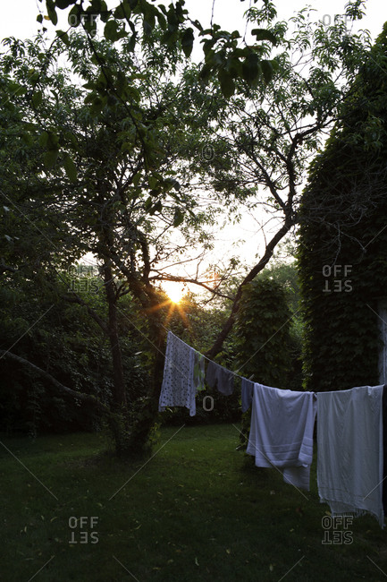 White laundry is drying outside on a summer day