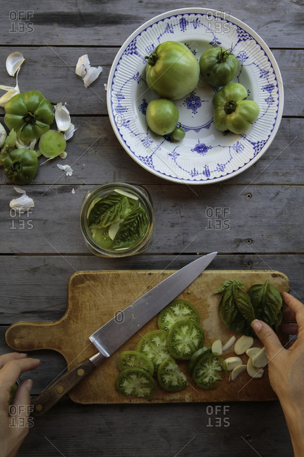 Woman making pickled green tomatoes