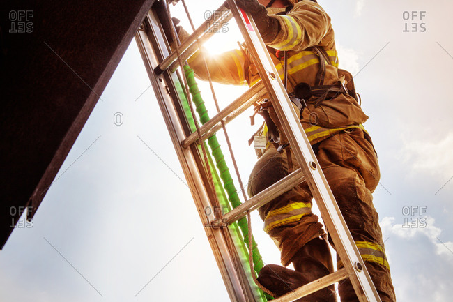 Fireman climbing up a ladder