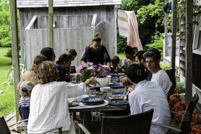 Young people eating and talking during garden party