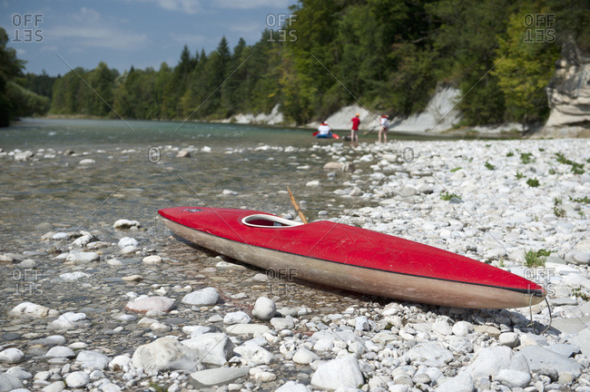 A kayak on a rocky beach