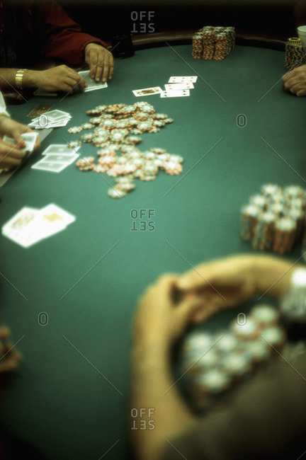 Group of people gambling at a casino blackjack table