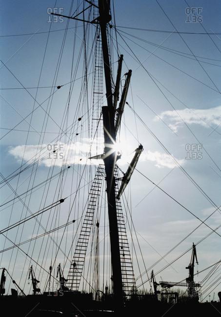 Ship\'s mast and rigging in silhouette