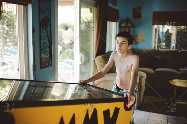 Boy playing pinball machine
