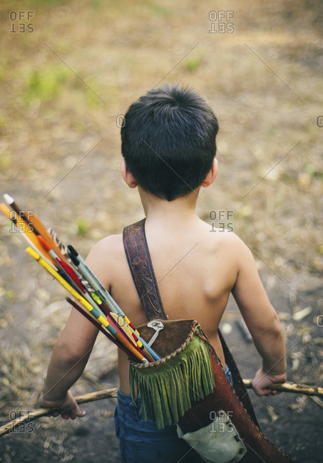 Rear view of little boy with quiver, bow and arrows