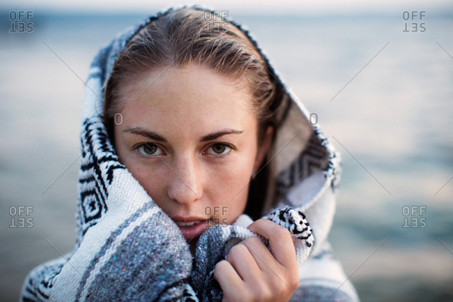 A woman covering herself with a blanket