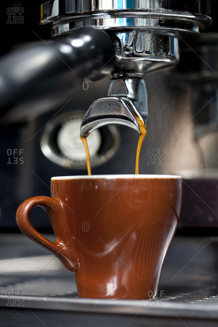 A double shot of espresso being poured from an espresso maker