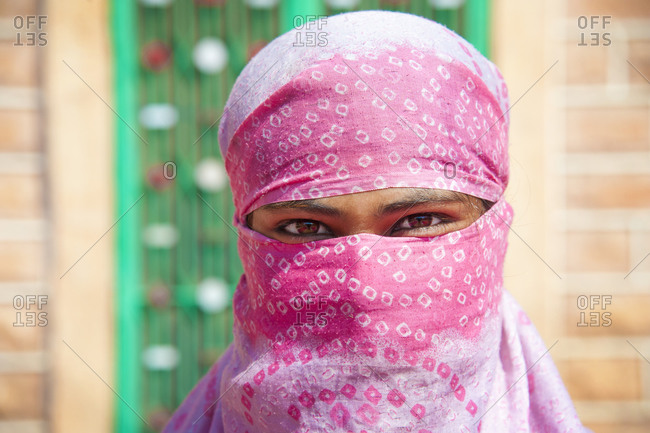 Woman worker smiling behind her head scarf in Jodhpur, India