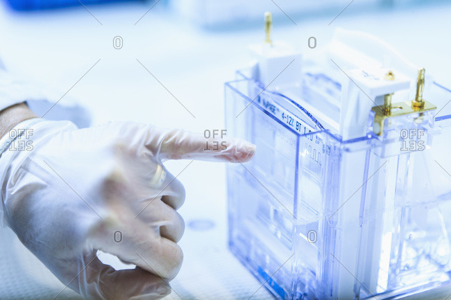 Scientist pointing little finger on medical equipment