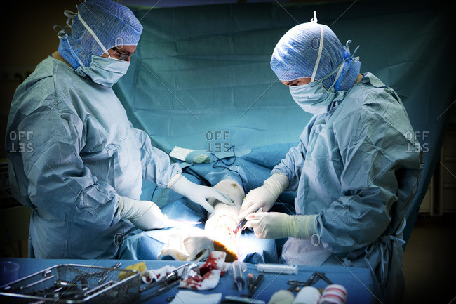 Septic surgeons perform surgery by removing an internal fixation in the ankle following an infection