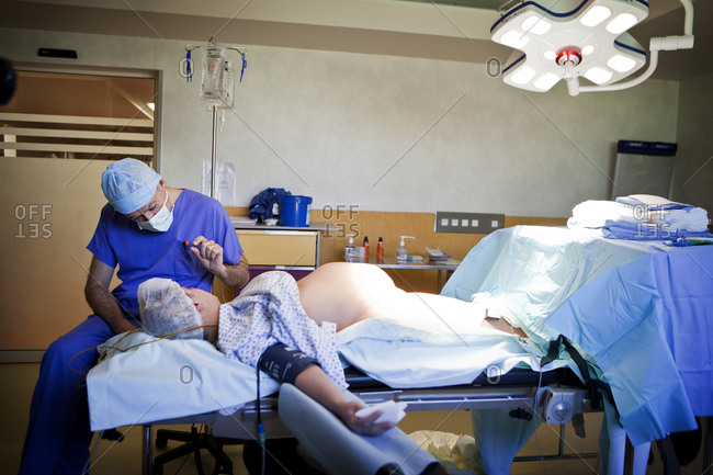 Doctor prepping patient for cesarean delievery