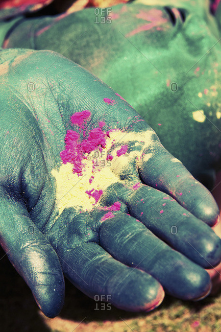 Young woman holding powder paint on holi festival