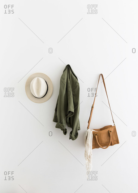 Female accessories and jacket hanging on wall