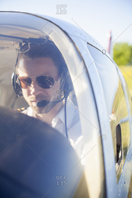 Air pilot in cockpit of propeller aeroplane