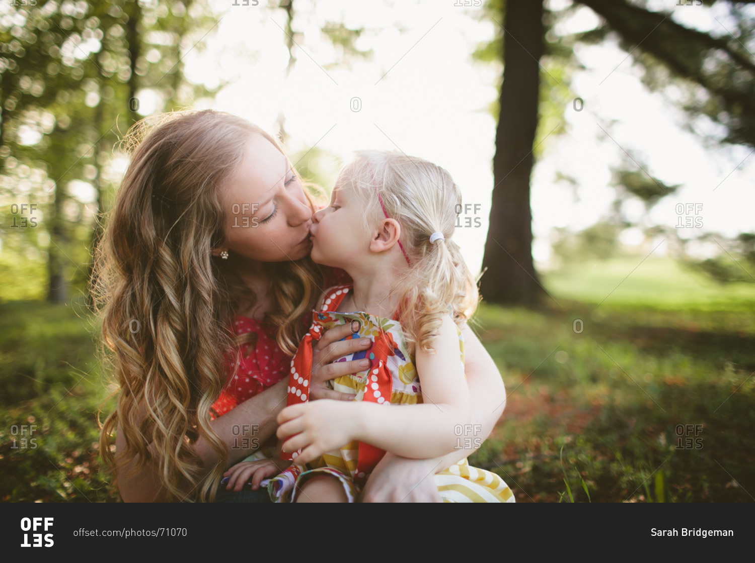 Mom kissing daughter