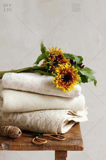 Sunflowers on a stack of folded blankets