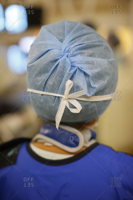 Back view of medical nurse wearing a surgical hair net