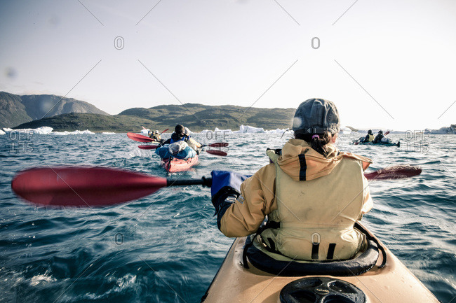 Rear view of a woman sea kayaking