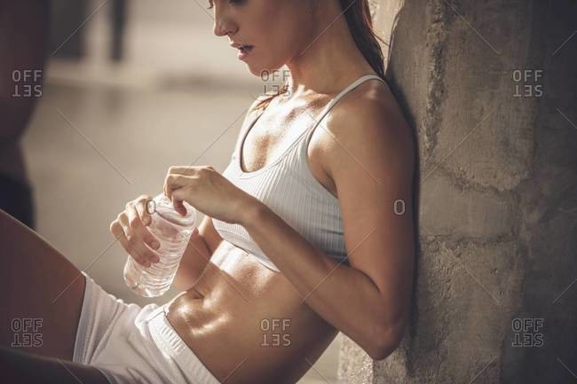 Caucasian woman resting in gym