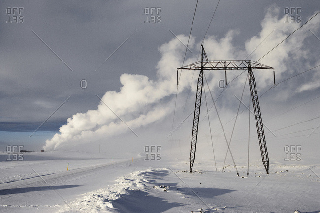 Power Lines in Winter Landscape with Steam from nearby Geothermal Power Plant in Background, Hellisheidi, Iceland