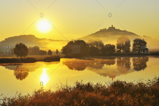 Wachsenburg Castle with Morning Mist and Sun reflecting in Lake at Dawn, Drei Gleichen, Thuringia