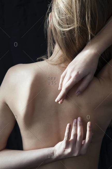 Woman Reaching her Hands Behind her Back