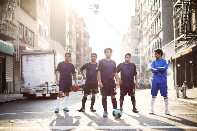 Soccer team walking in sunlit street