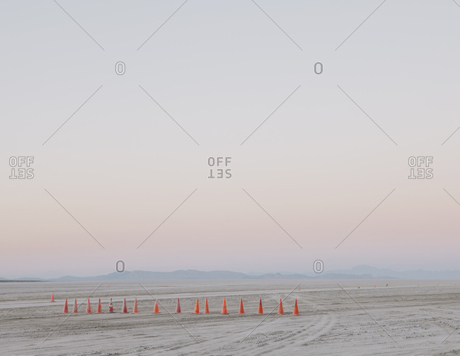 Row of traffic cones on the flat desert surface of  Black Rock, Nevada
